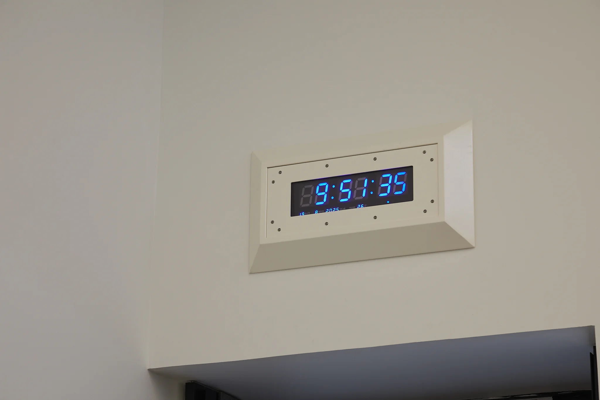 Sung Tieu,, Anti-Vandal Clock, (New Delhi), 2023. polyester powder coated steel casing, polycarbonate anti-vandal LED screen, tamper resistant screws, battery, 45.4 x 83 x 8 cm 17 7/8 x 32 5/8 x 3 1/8 inches.. Photo: Thakueng Withusuwan. Courtesy of the Jim Thompson Art Center and the James H.W. Thompson Foundation © Jim Thompson Art Center